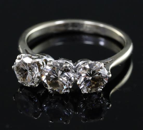 An 18ct white gold and three stone diamond ring, size P.